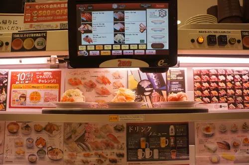 High-speed sushi delivery lane at a conveyor-belt sushi restaurant in Tokyo