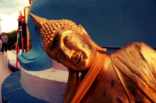 Golden Buddha statues and offerings at Wat Phra Yai