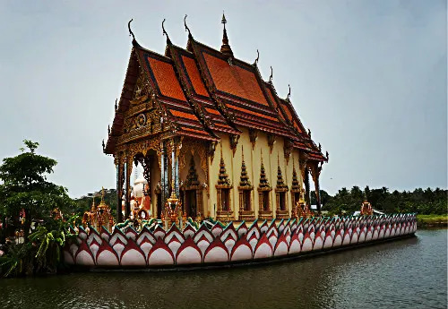 The temple of Wat Plai Laem floating on the lake