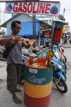 Fuel in glass bottles at a roadside stand on Koh Samui
